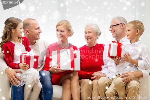 Image of smiling family with gifts at home