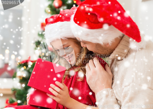 Image of smiling father and daughter opening gift box