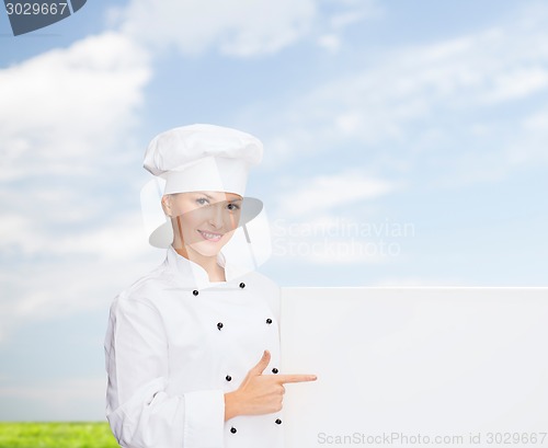 Image of smiling female chef with white blank board