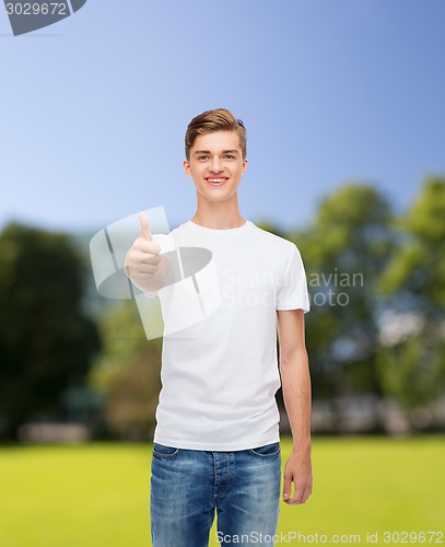 Image of smiling man in white t-shirt showing thumbs up
