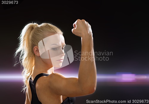 Image of close up of athletic woman flexing her biceps