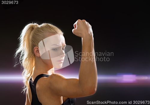 Image of close up of athletic woman flexing her biceps