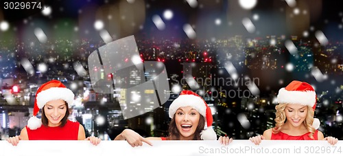 Image of women in santa helper hat with blank white board