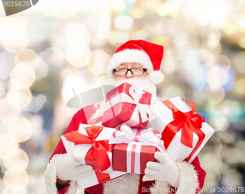 Image of man in costume of santa claus with gift boxes