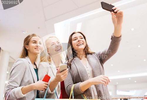 Image of women with smartphones shopping and taking selfie