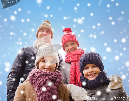 Image of happy family in winter clothes outdoors