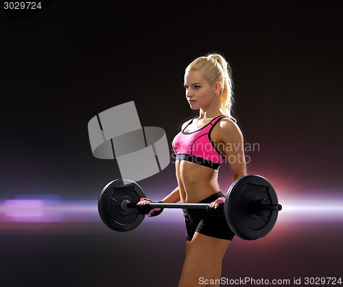 Image of sporty woman exercising with barbell