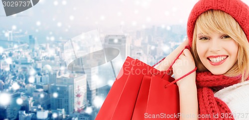 Image of smiling young woman with shopping bags