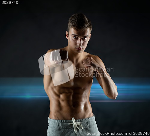 Image of young man in fighting or boxing position