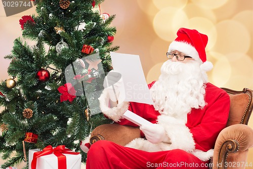 Image of man in costume of santa claus with letter