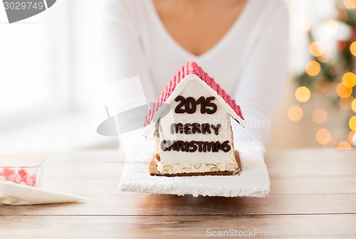 Image of close up of woman showing gingerbread house