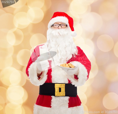 Image of santa claus with glass of milk and cookies
