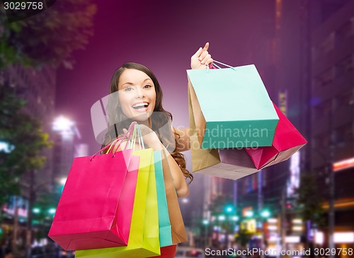 Image of smiling young woman with shopping bags