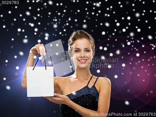 Image of smiling woman with white blank shopping bag