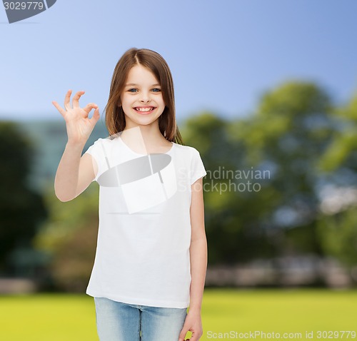 Image of smiling little girl in white blank t-shirt