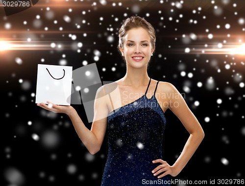 Image of smiling woman with white blank shopping bag