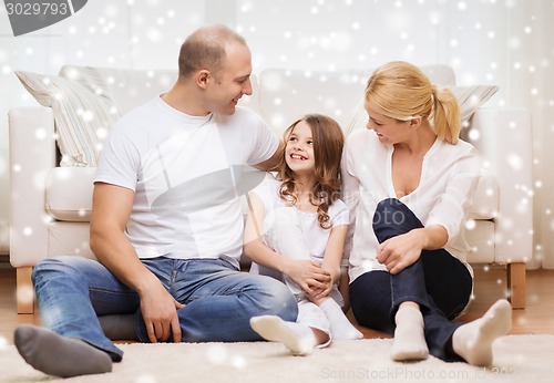 Image of smiling parents and little girl at home