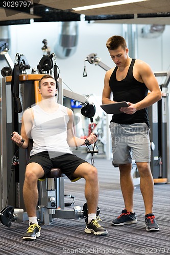 Image of man exercising on gym machine