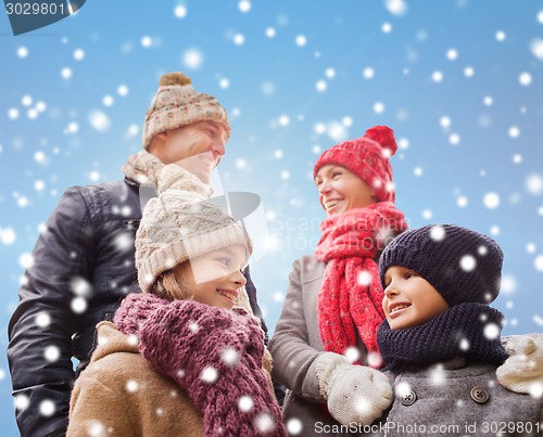 Image of happy family in winter clothes outdoors