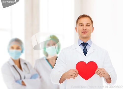 Image of smiling male doctor with red heart