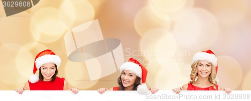 Image of women in santa helper hat with blank white board