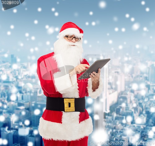 Image of man in costume of santa claus with tablet pc