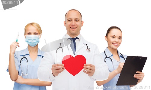 Image of group of smiling doctors with red heart shape