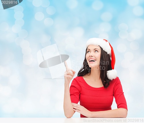 Image of smiling woman in santa helper hat