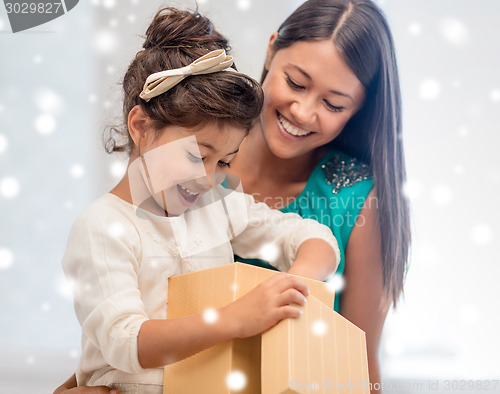 Image of happy mother and child girl with gift box