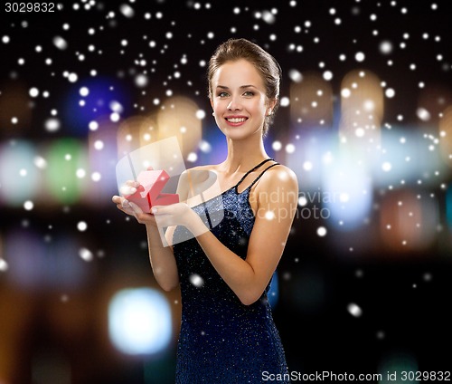 Image of smiling woman holding red gift box