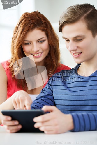 Image of smiling students with tablet pc at school