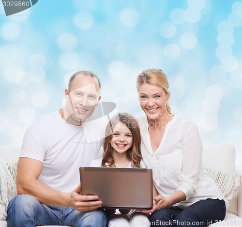 Image of smiling family with laptop