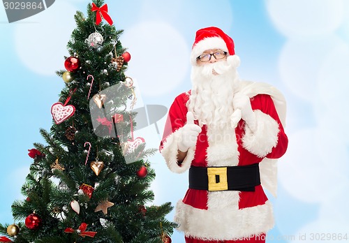 Image of santa claus with bag and christmas tree