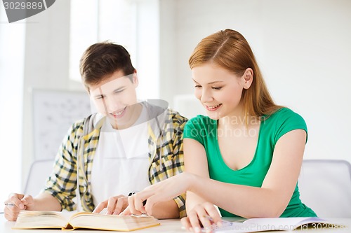 Image of students with textbooks and books at school