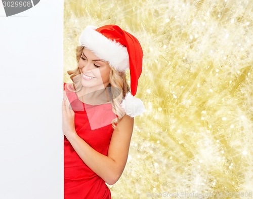 Image of smiling young woman in santa hat with white board