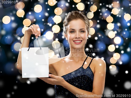 Image of smiling woman with white blank shopping bag