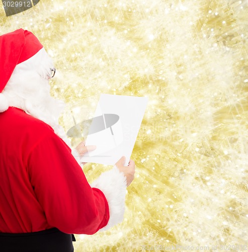 Image of man in costume of santa claus with letter