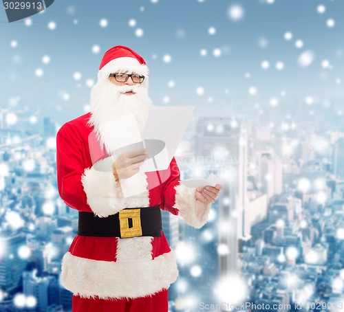 Image of man in costume of santa claus with letter