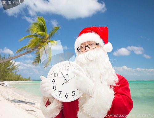 Image of man in costume of santa claus with clock