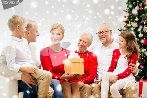 Image of smiling family with gift at home