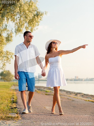 Image of smiling couple walking outdoors