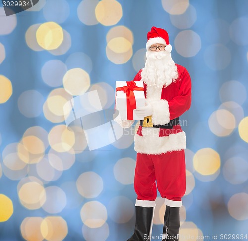 Image of man in costume of santa claus with gift box
