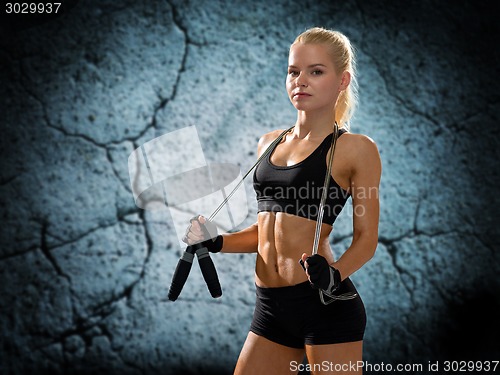 Image of young sporty woman with jumping rope