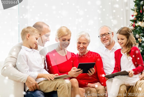 Image of smiling family with tablet pc computers at home
