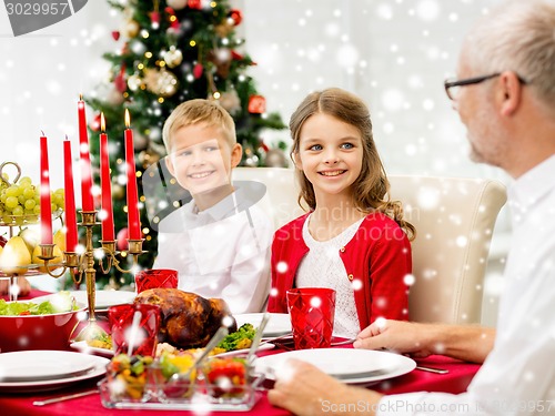 Image of smiling family having holiday dinner at home