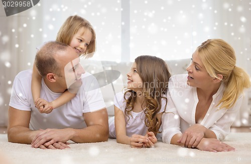 Image of smiling parents and two little girls at home