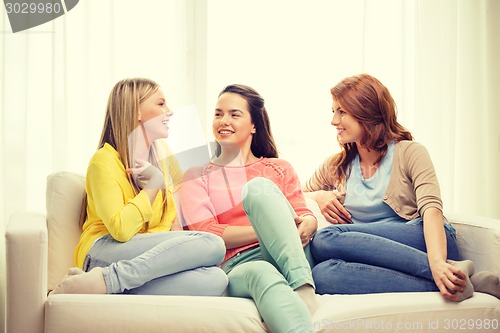 Image of three girlfriends having a talk at home
