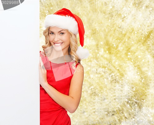 Image of smiling young woman in santa hat with white board