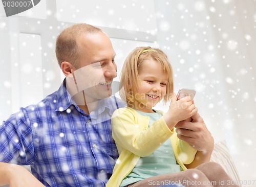 Image of happy father and daughter with smartphone