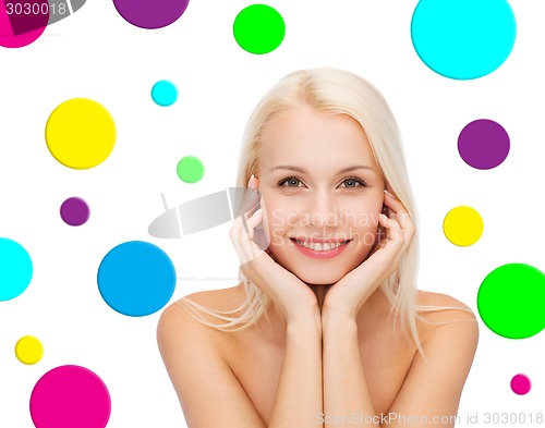 Image of beautiful young woman over polka dot background